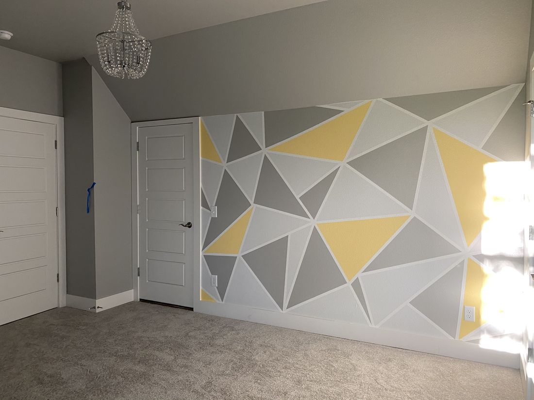 Custom geometric painted accent wall in gray and gold
