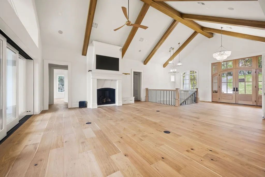Vaulted great room with a hand-finished fireplace surround