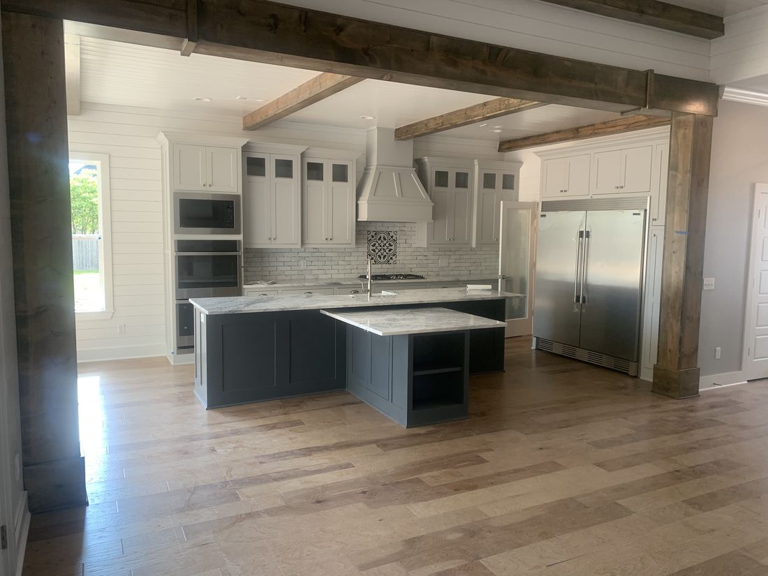 Navy blue kitchen island with white cabinetry