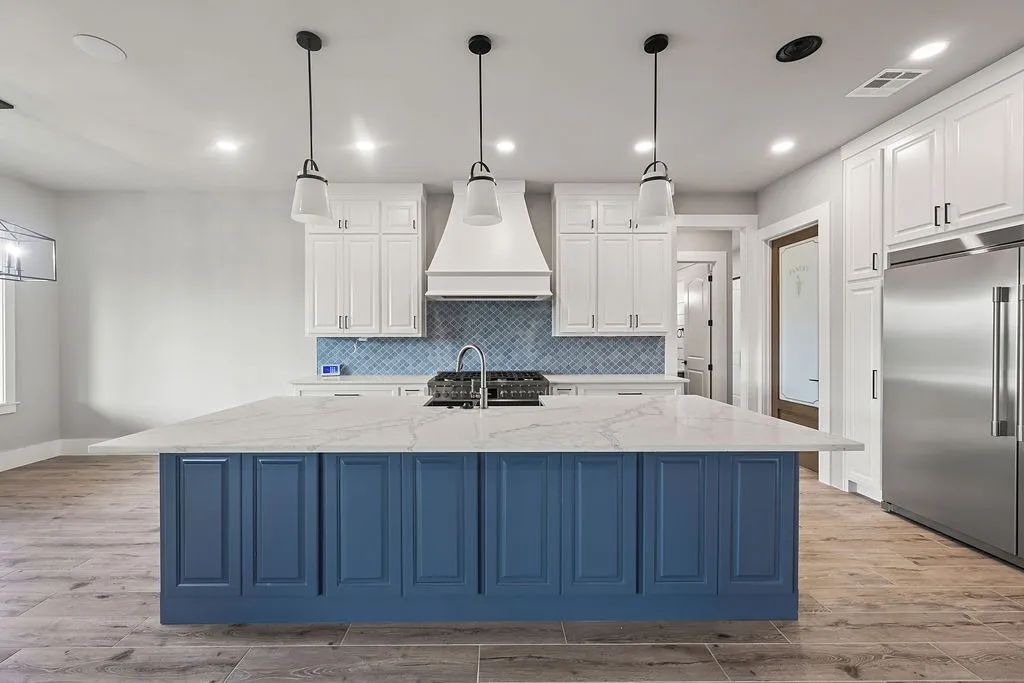 Navy kitchen island with white perimeter cabinetry