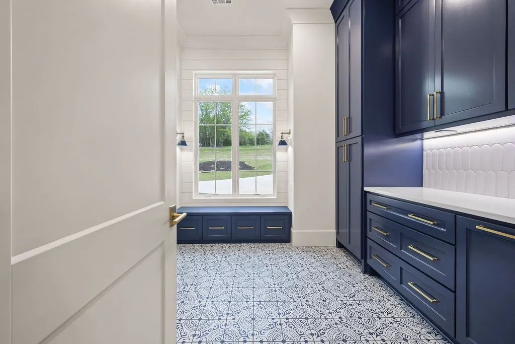 Navy mudroom cabinetry with patterned tile floor