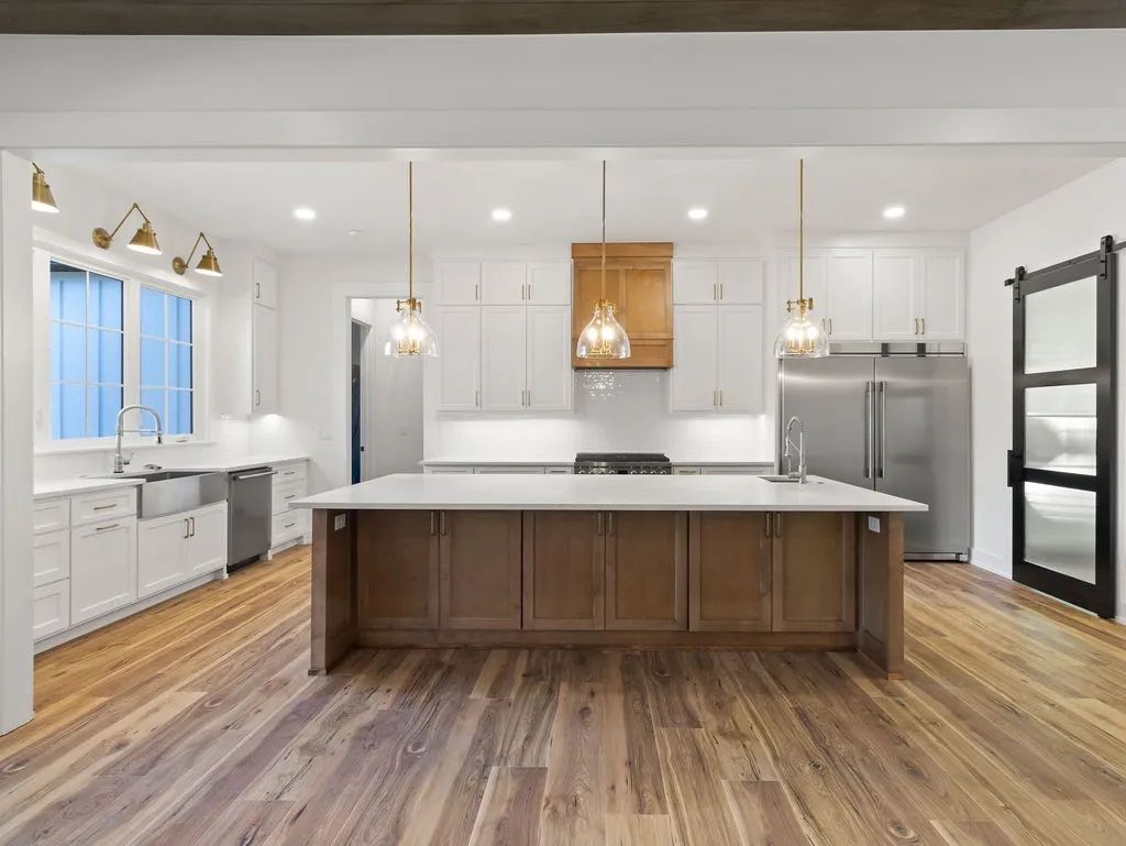 Two-tone kitchen with white and stained wood cabinetry